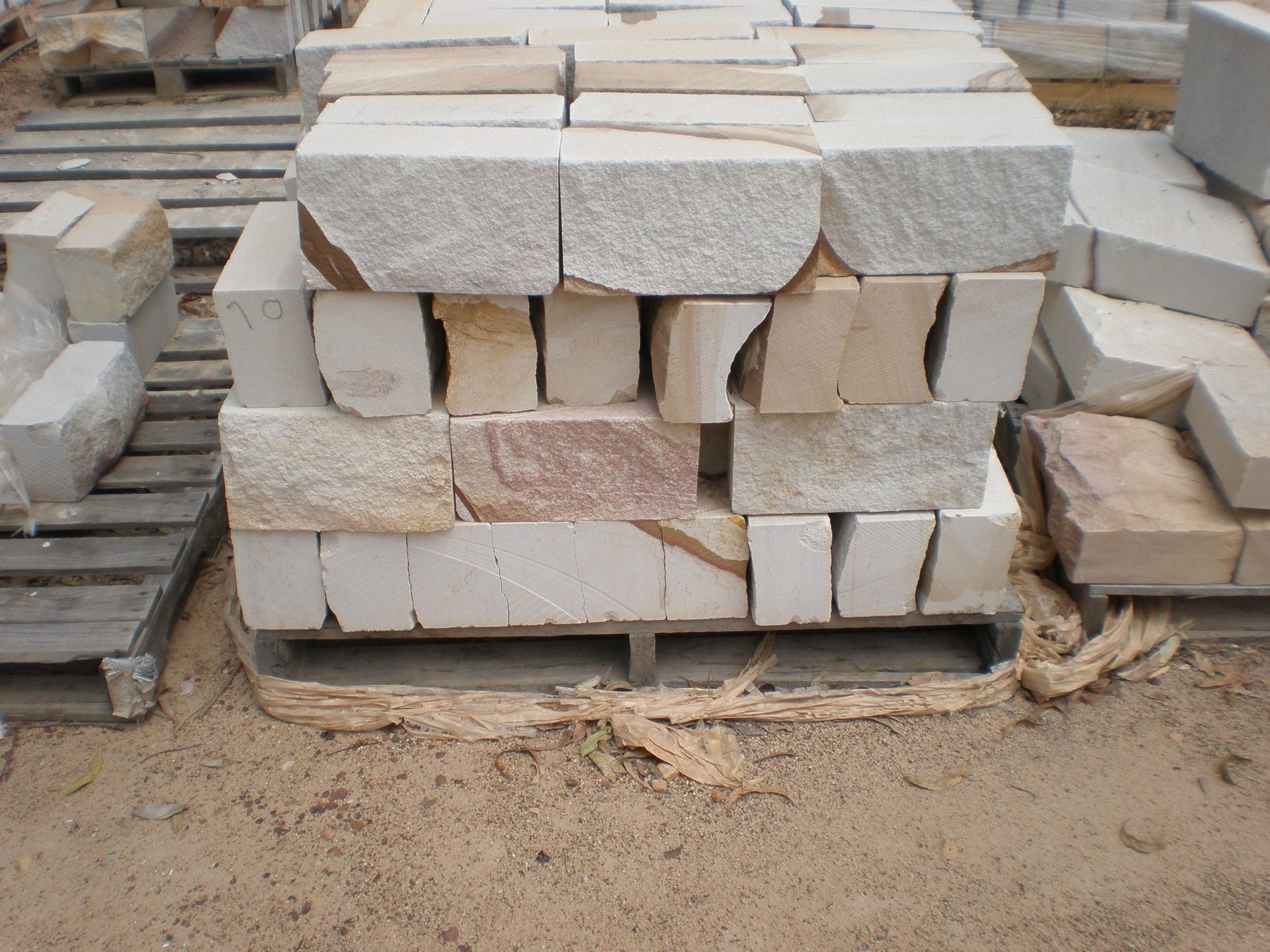 Stack of Beige and Tan Stone Blocks on a Wooden Pallet — Australian Sandstone Products In Toowoomba, QLD