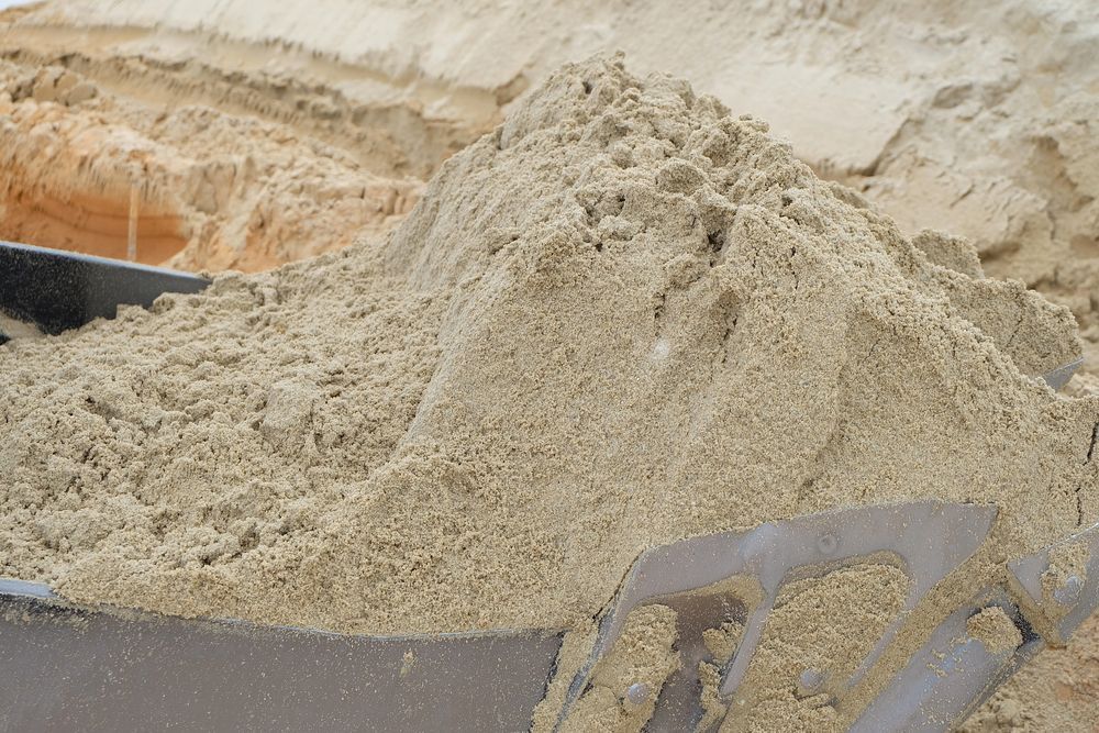 Pile of light brown sand, close-up, in a metal container — Australian Sandstone Products In Canungra, QLD