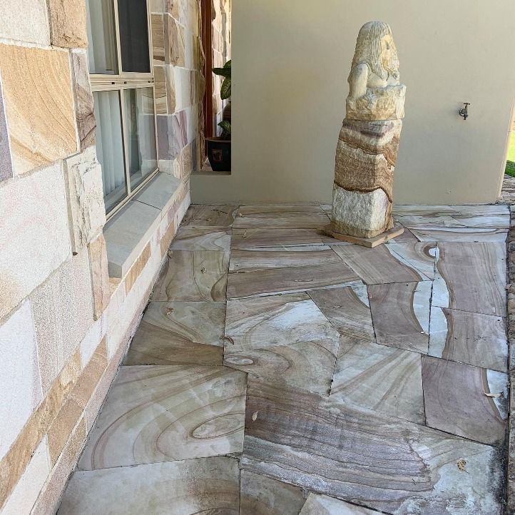 Stone Walkway Leading to a House With a Statue in Front of It — Australian Sandstone Products In Warwick, QLD