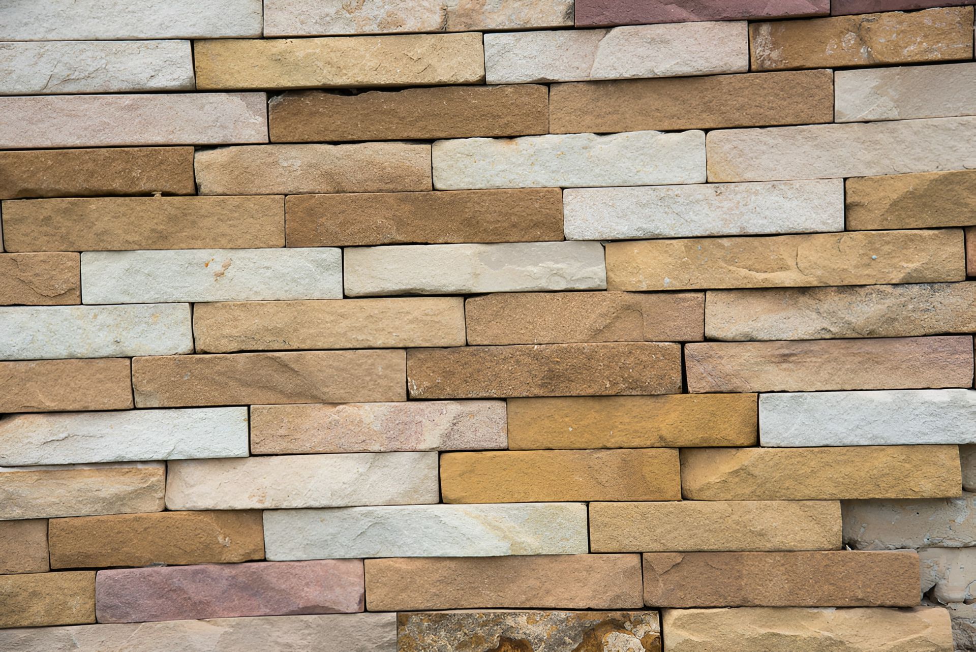 A Close Up Of A Brick Wall Made Of Different Colored Bricks — Australian Sandstone Products In Maleny, QLD