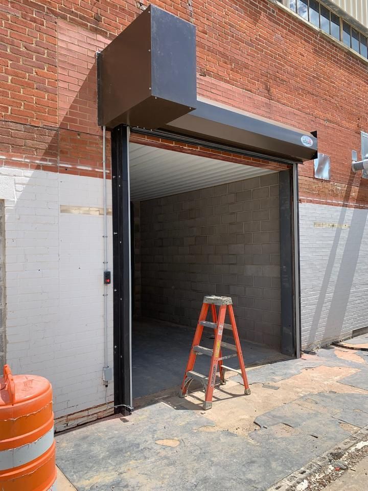 A ladder is sitting in front of a garage door