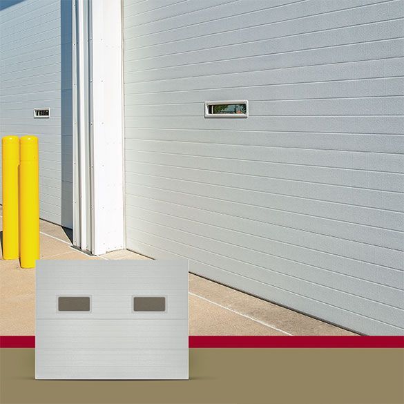 A white garage door with two yellow poles in front of it