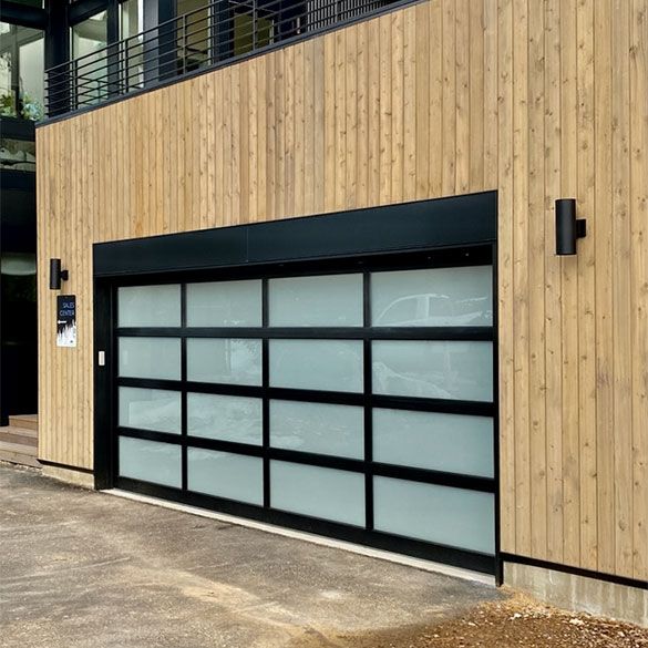 A modern garage door with a wooden siding and a black frame.