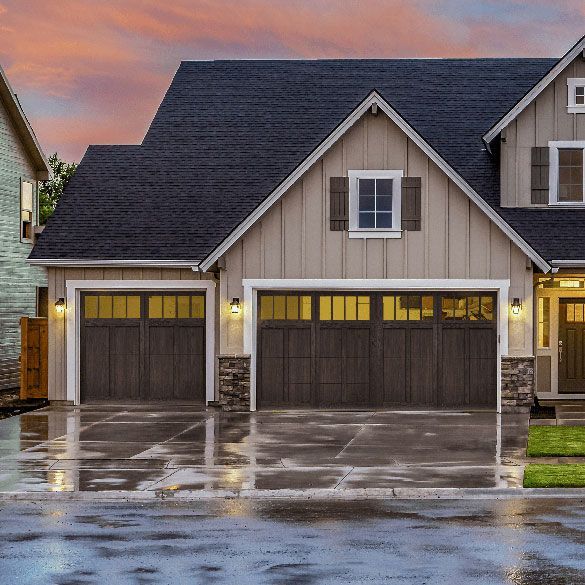 A house with two garage doors on a rainy day