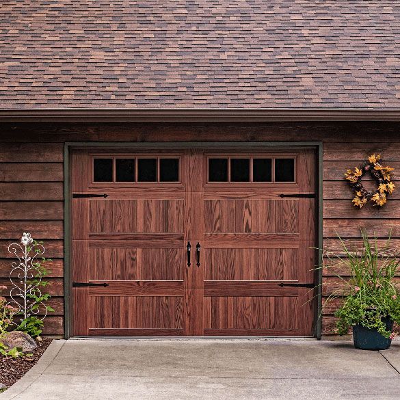 A wooden garage door with a wreath on it