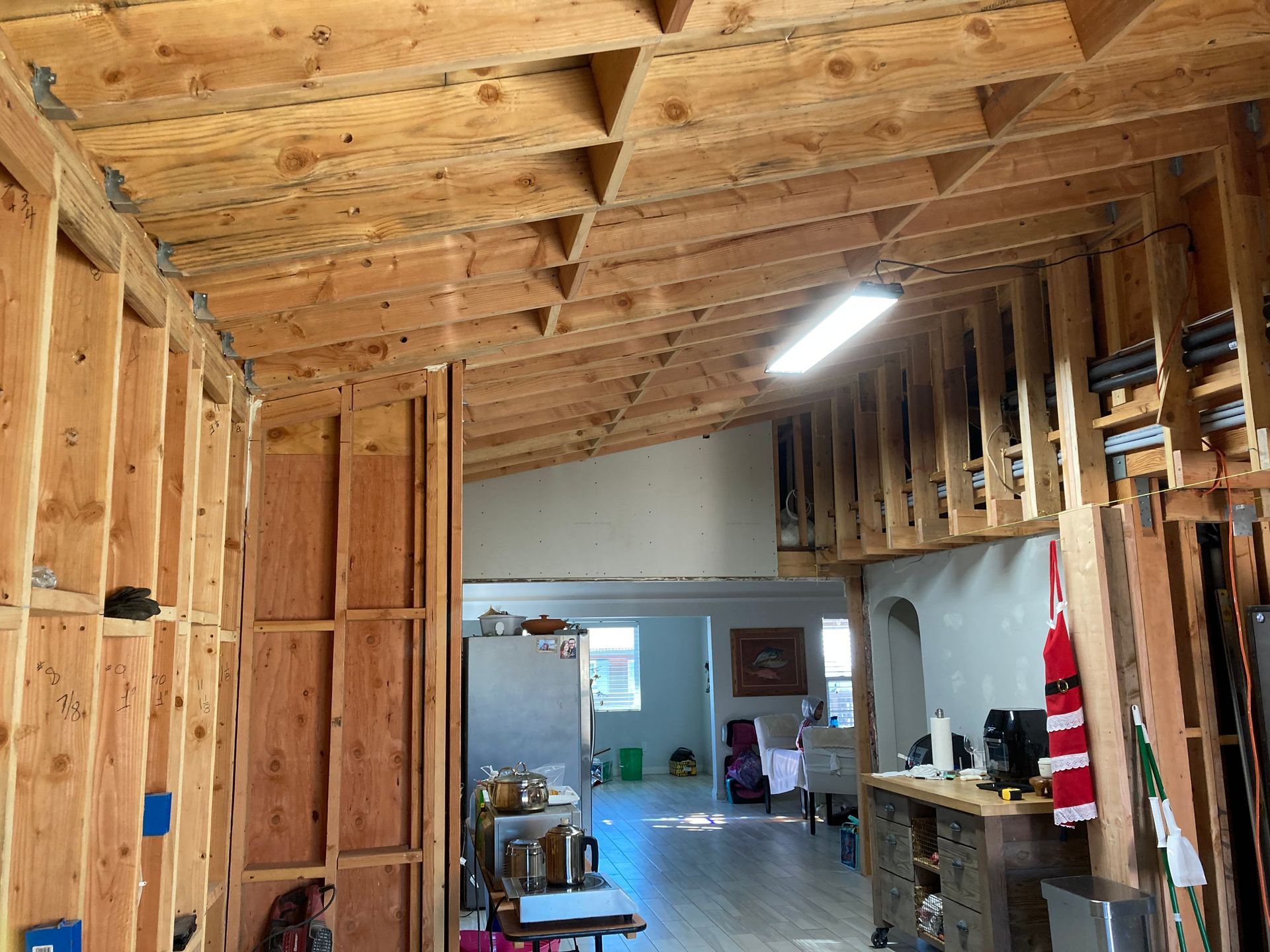 Interior view of a building under construction, showing exposed wooden framing.