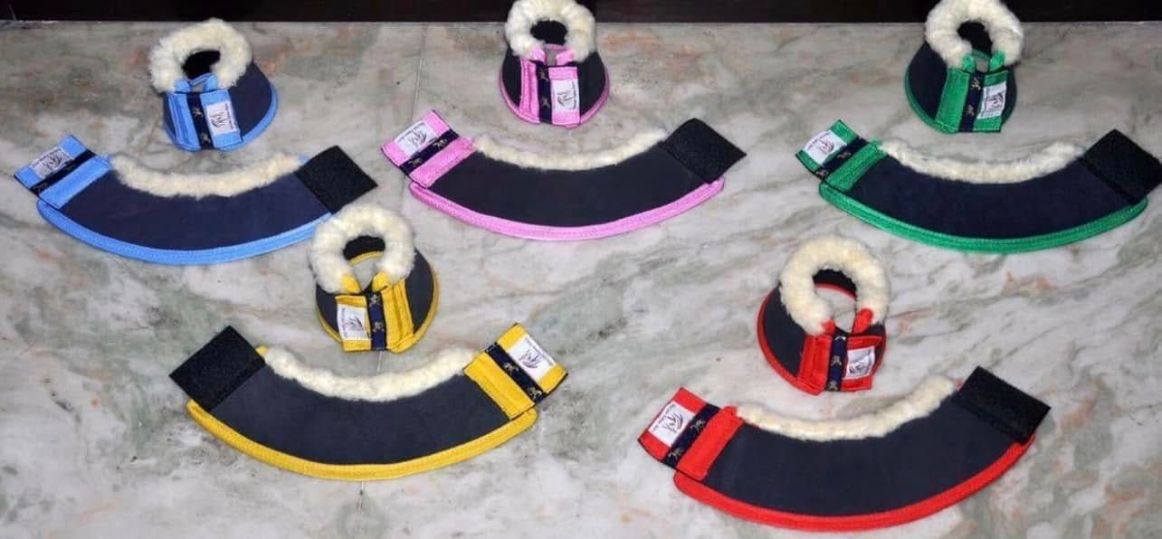 A bunch of different colored horse boots are sitting on a table. — Paint Horse Saddlery In Taree, NSW