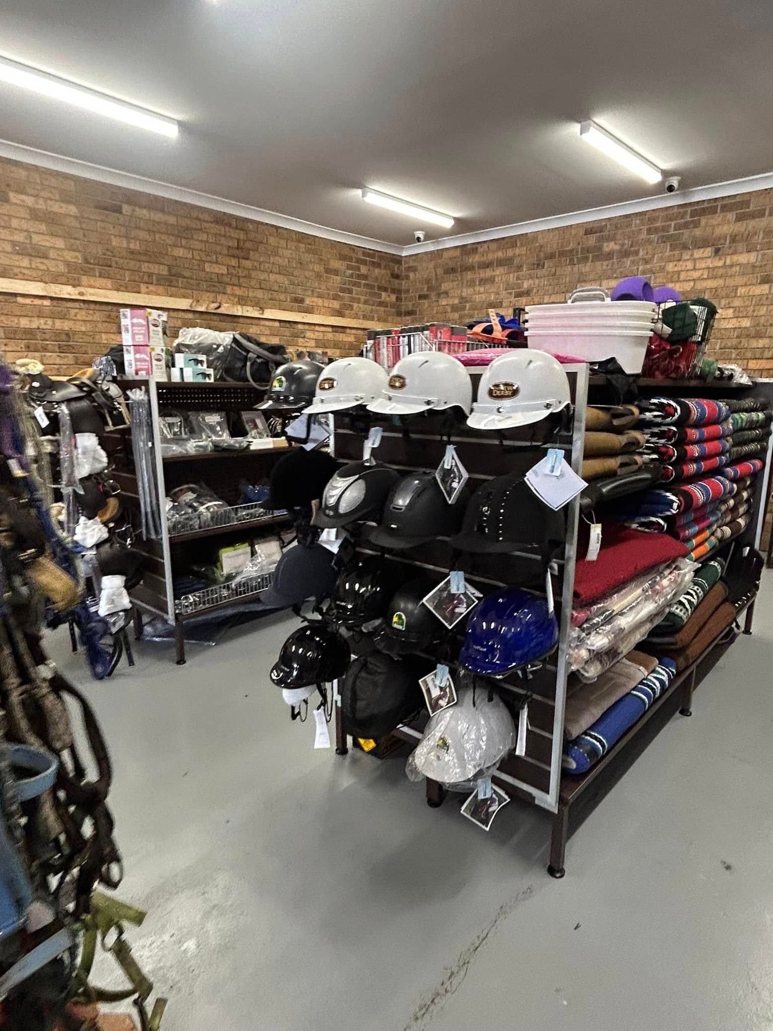 A store filled with lots of hats and helmets. — Paint Horse Saddlery In Taree, NSW