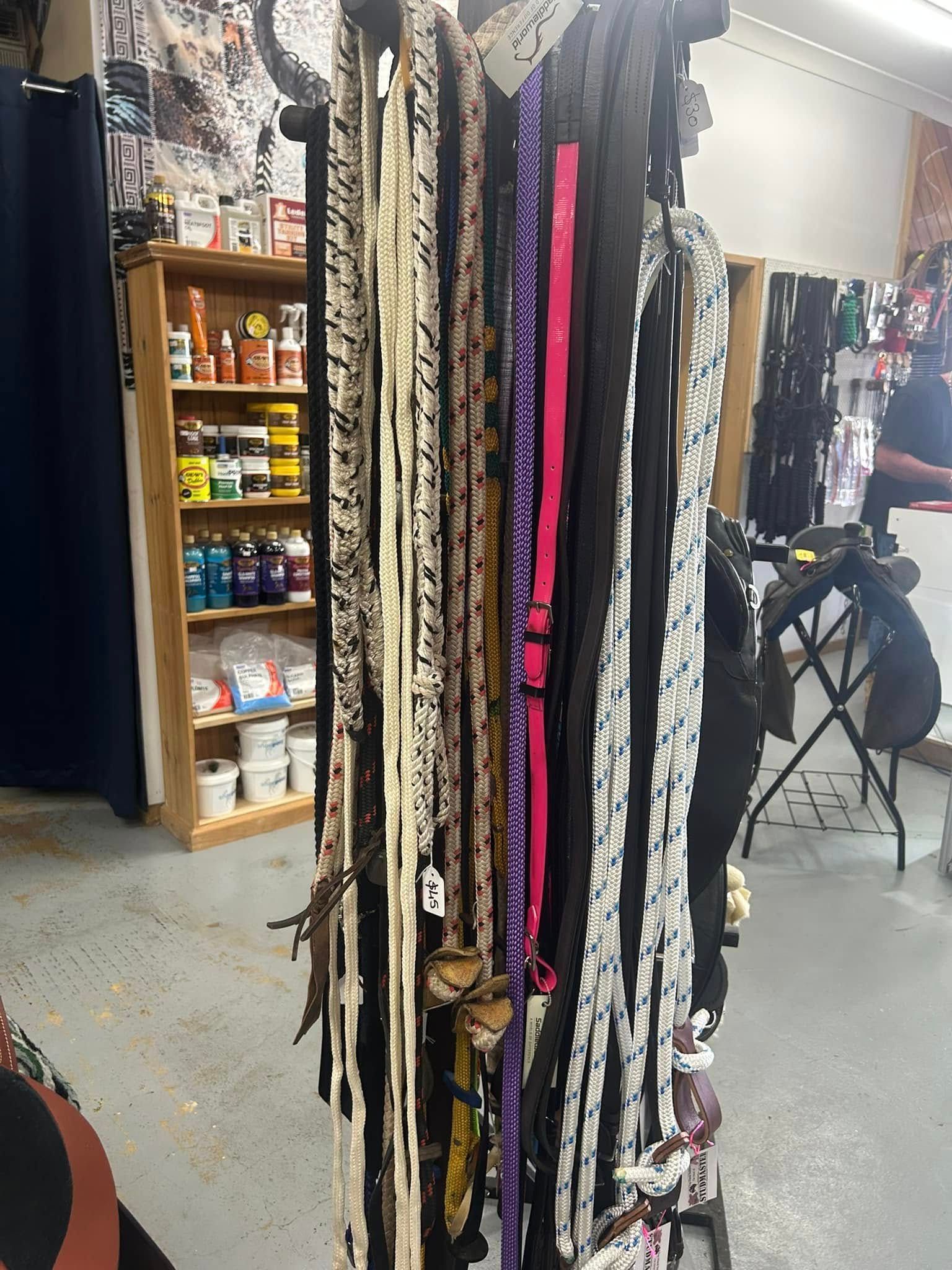 A bunch of leashes are hanging on a rack in a store — Paint Horse Saddlery In Taree, NSW