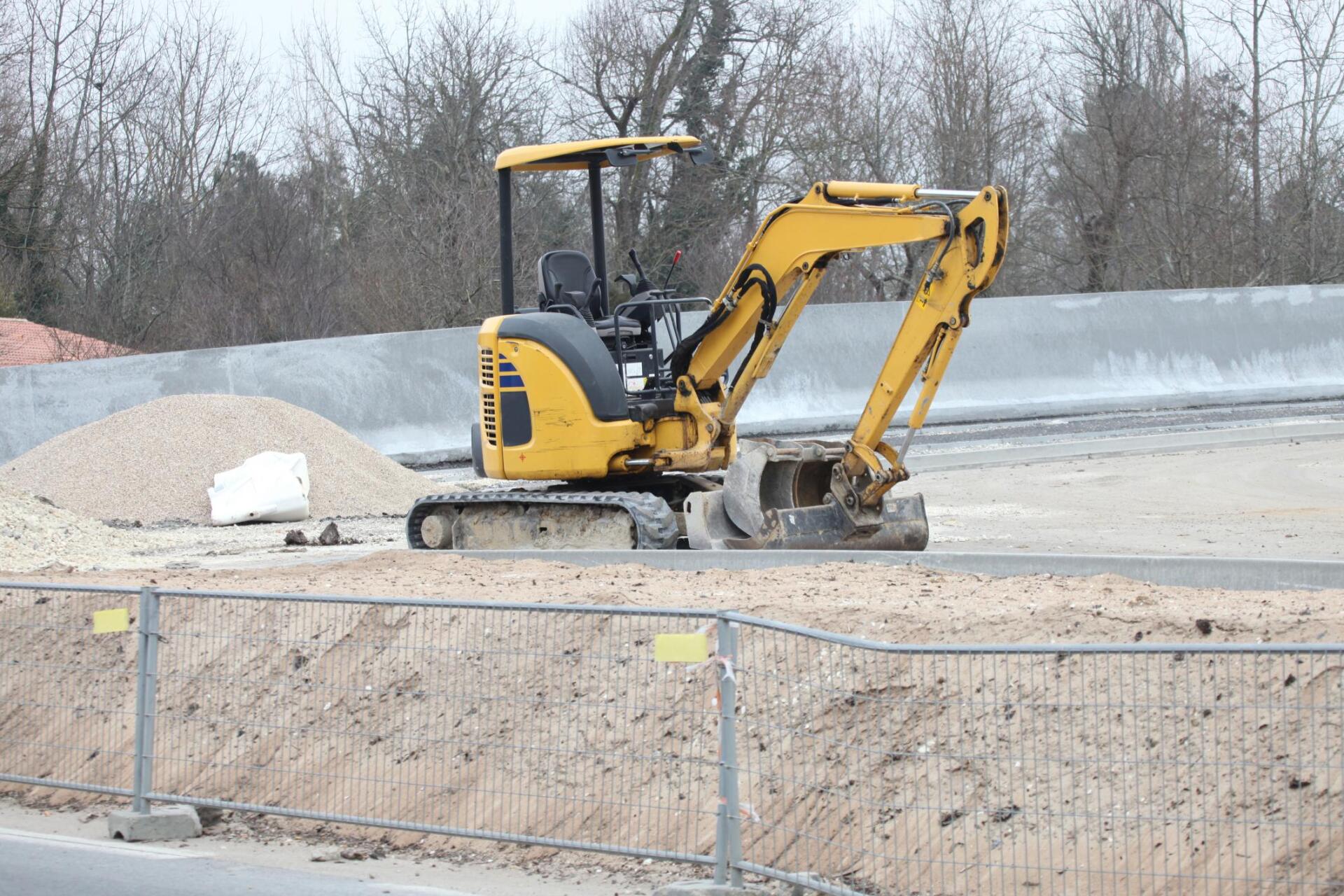 excavator grading the sand