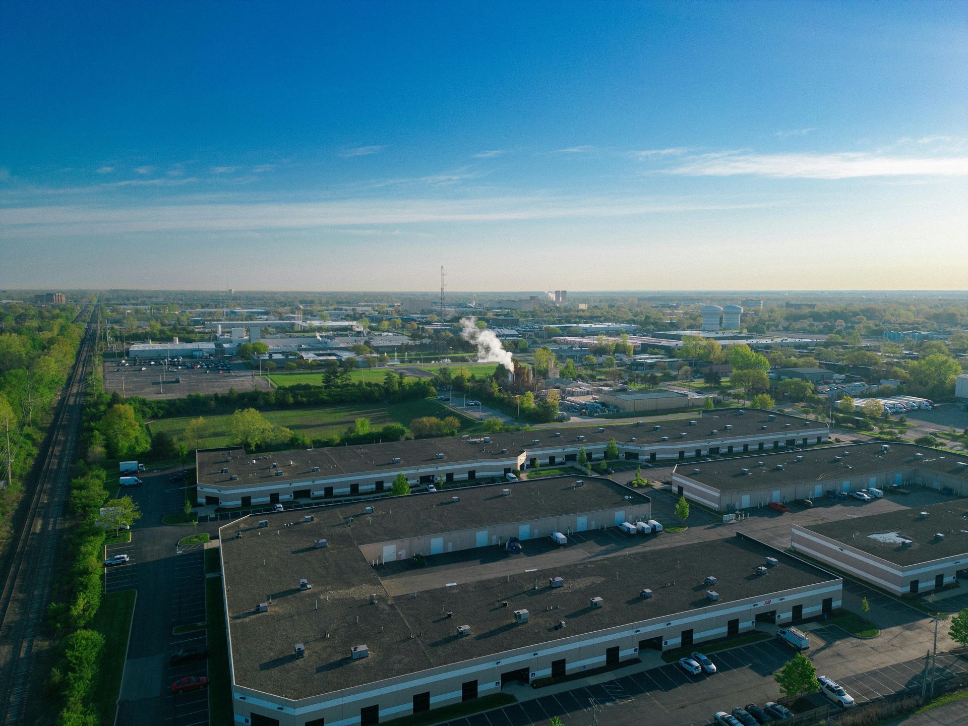 Aerial view of a sprawling industrial complex under a clear blue sky.