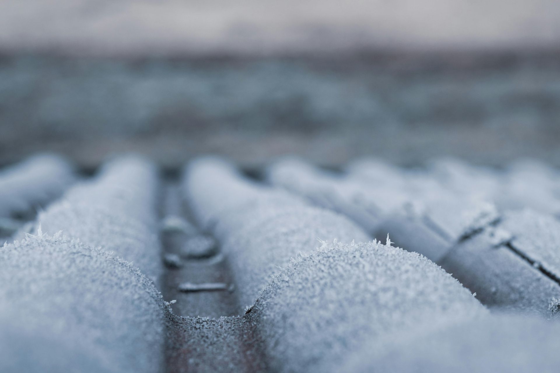 Close-up of a corrugated metal roof covered in frost.