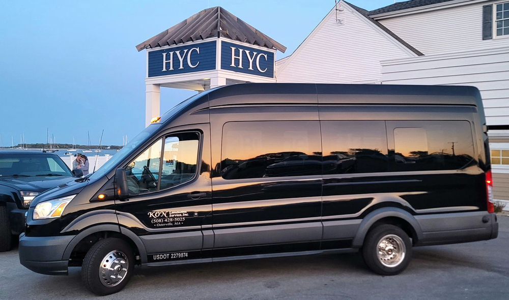 A black van is parked in front of a building that says hyc