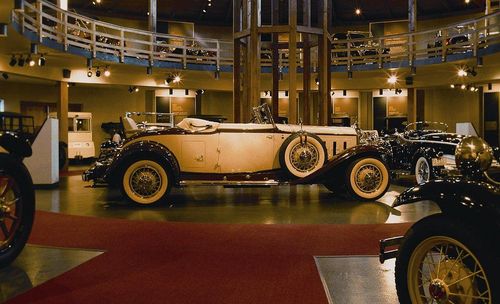 An old car is on display in a museum