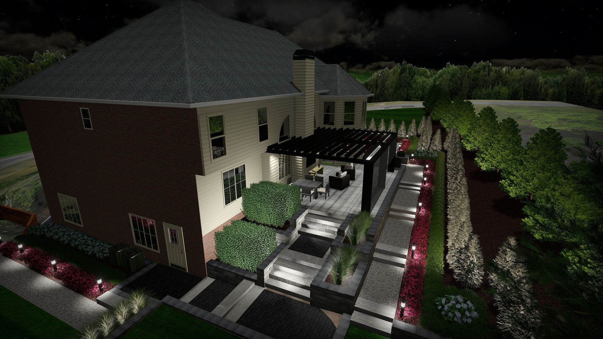 Night view of a house with lit patio, walkways, and landscaping; bushes and trees in the background.
