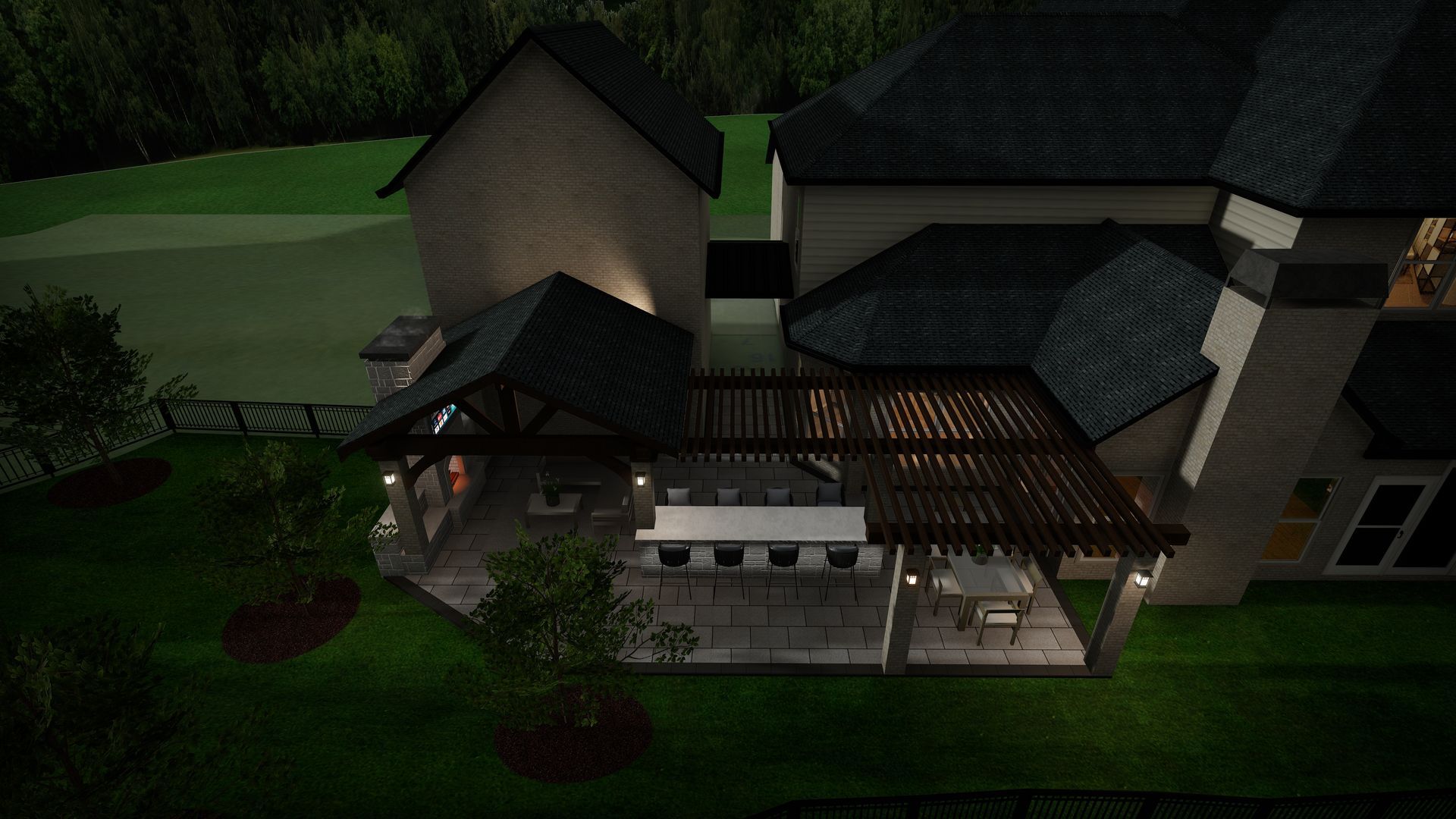 Nighttime view of a house with an outdoor kitchen under a pergola, illuminated with soft lighting.