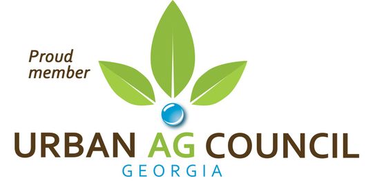 Logo of the Urban Ag Council Georgia, with green leaves, a blue orb, and text.