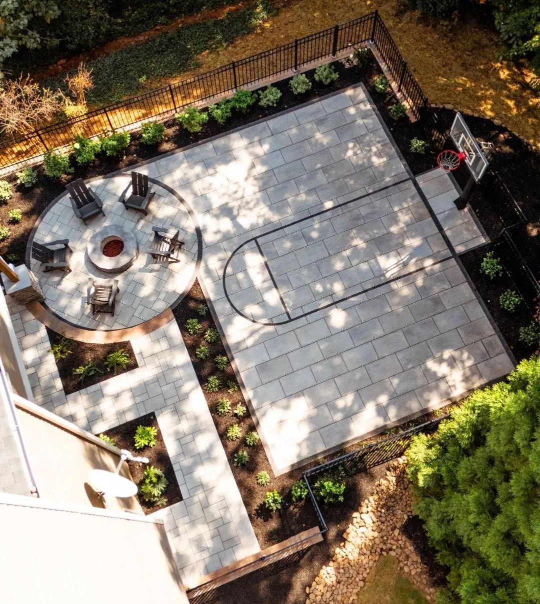 Overhead view of outdoor patio with basketball court, fire pit, and seating.