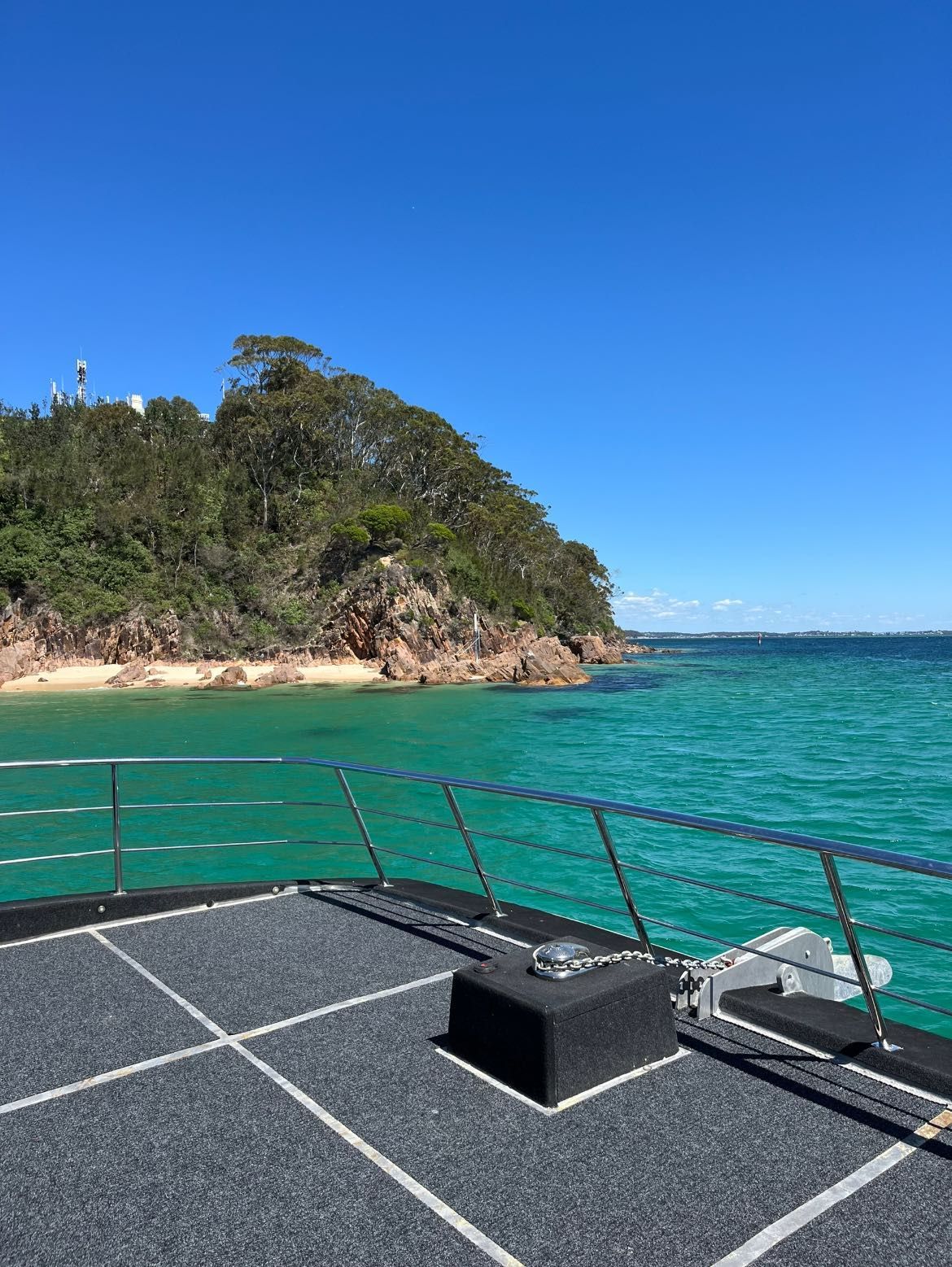 Boat Deck with Turquoise Water, Rocky Shore, and Blue Sky — YKnot Cruises in Nelson Bay, NSW