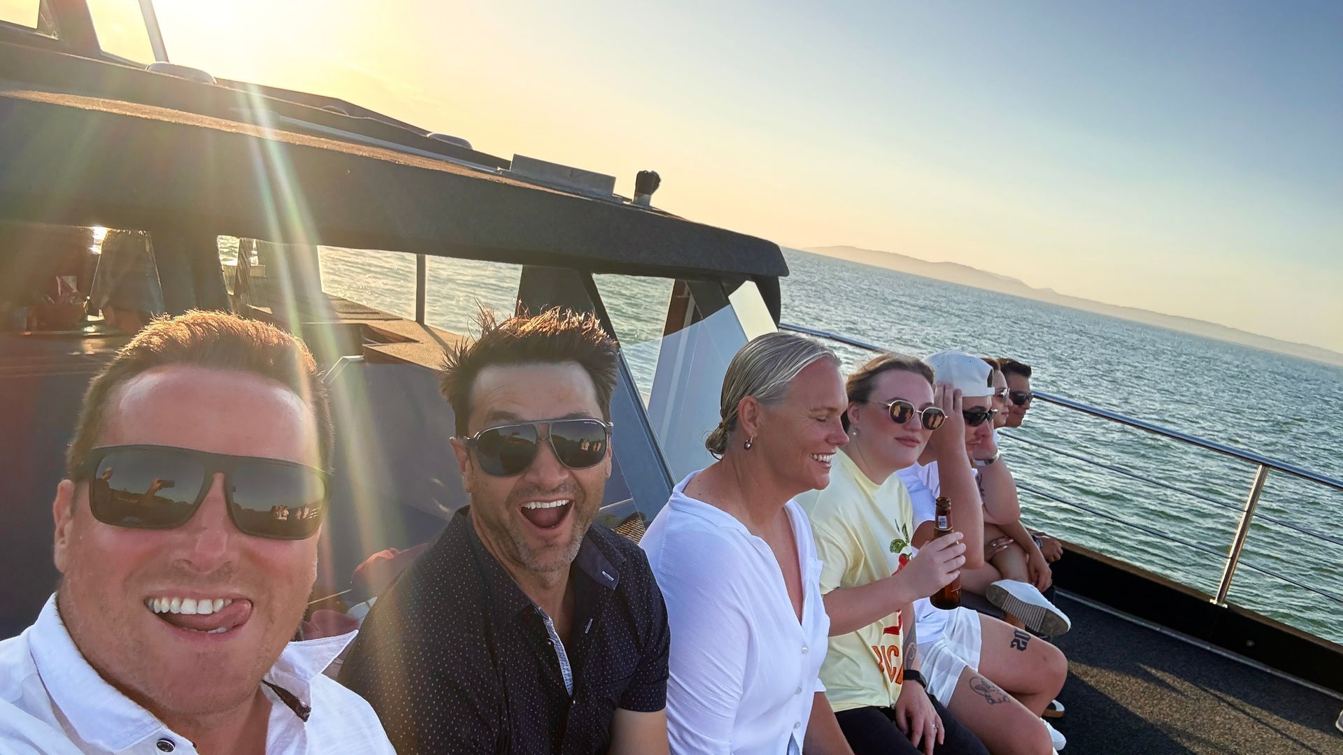 People on A Boat Looking at Dolphins in The Water — YKnot Cruises in Newcastle, NSW