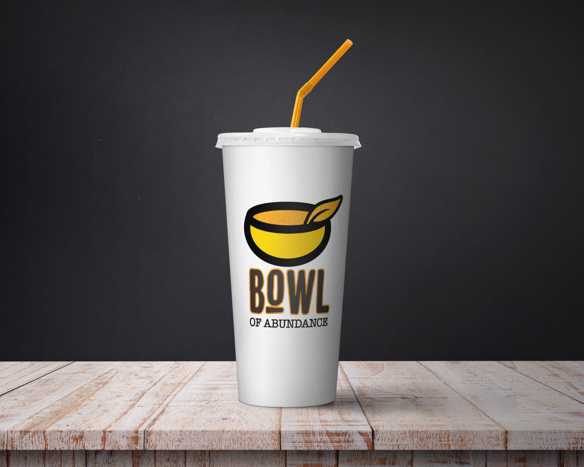 White drink cup with a yellow and brown logo that reads 