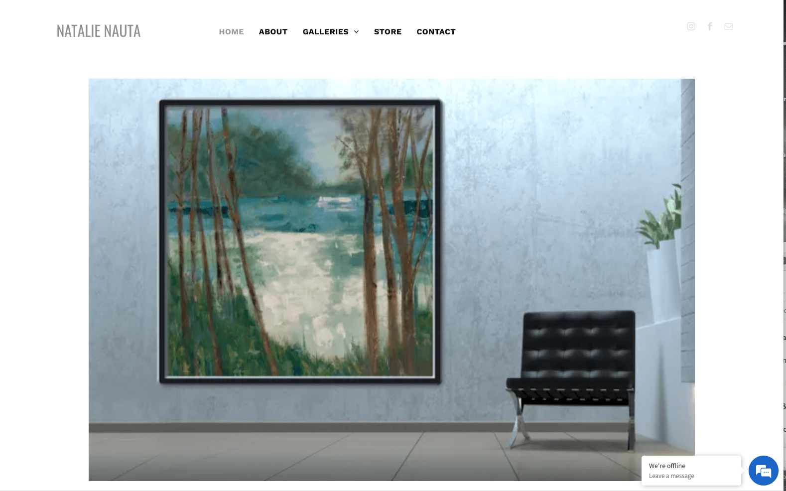 Painting of a waterscape hangs on a light blue wall, next to a black chair.