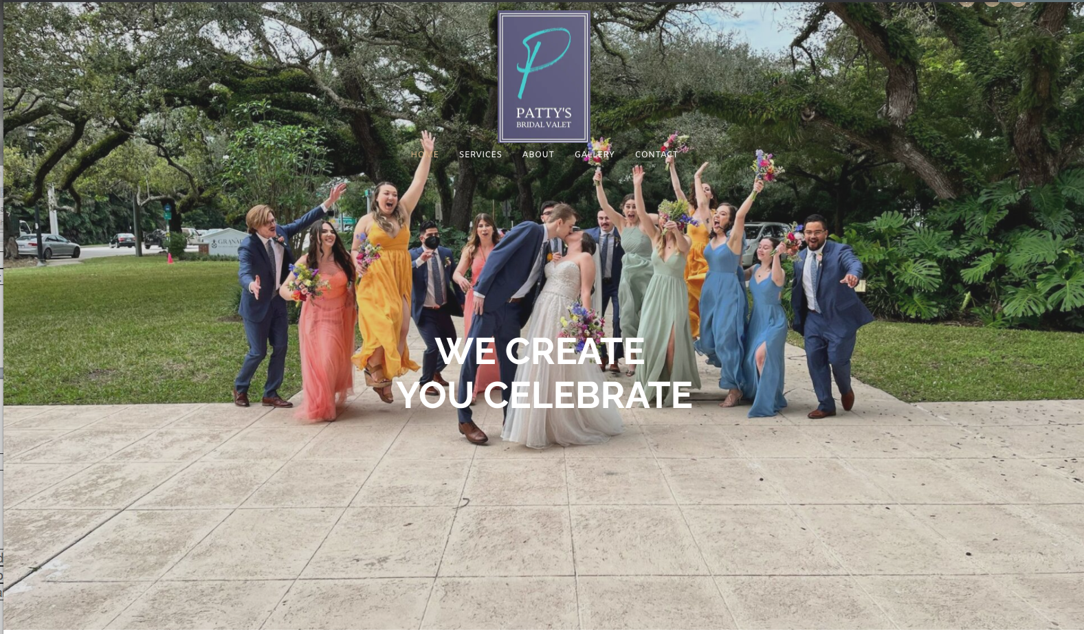 Wedding party celebrates outdoors. Couple kissing, surrounded by bridesmaids and groomsmen jumping and smiling. Green trees and building in the background.