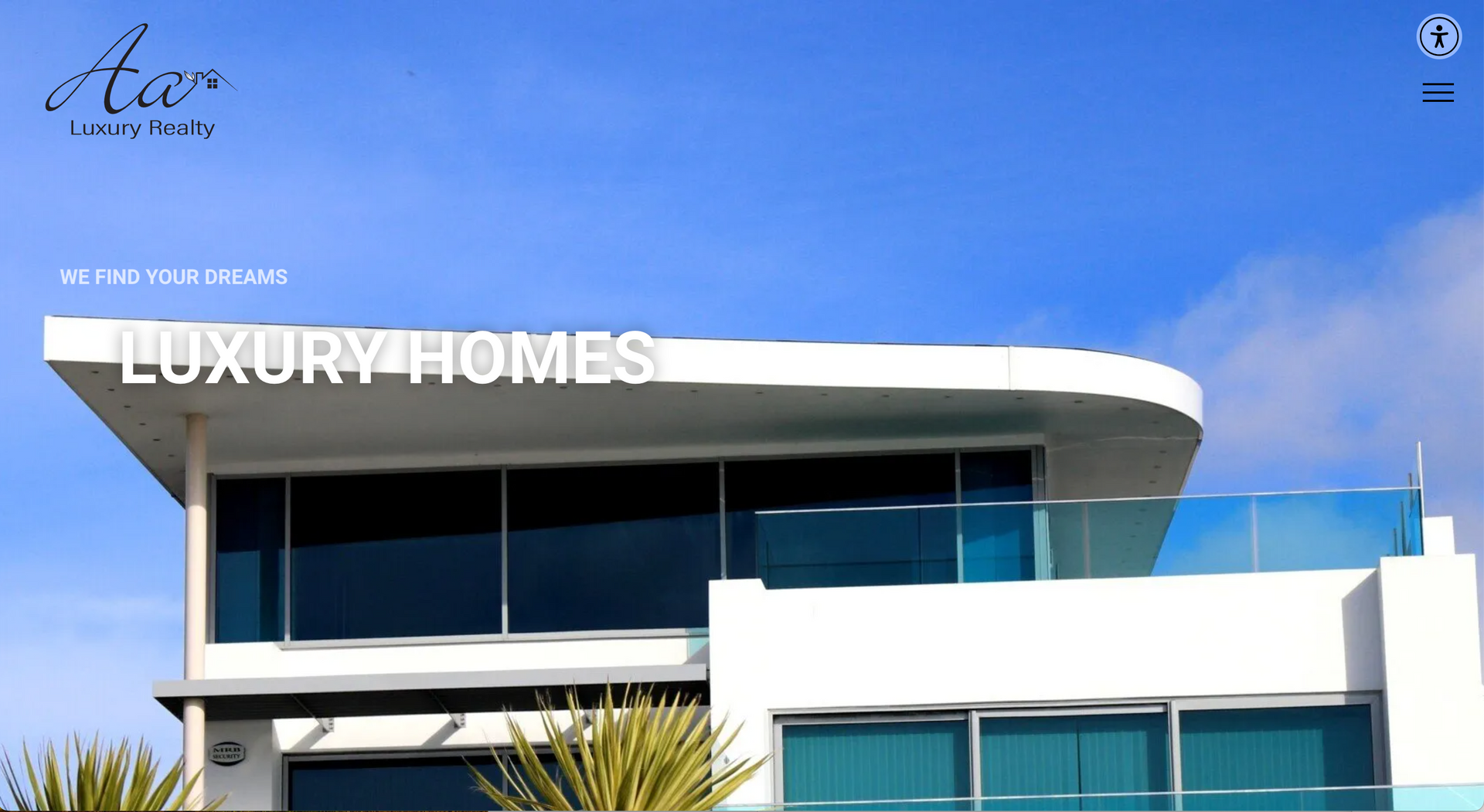 Modern white luxury home with large windows and a blue sky background. 