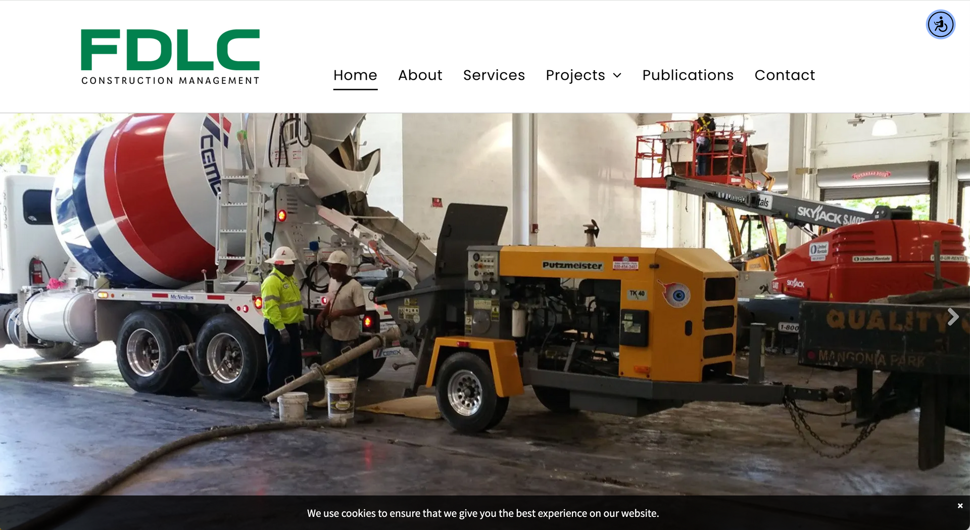 Concrete being poured on a construction site; a cement mixer truck and pump are in use.