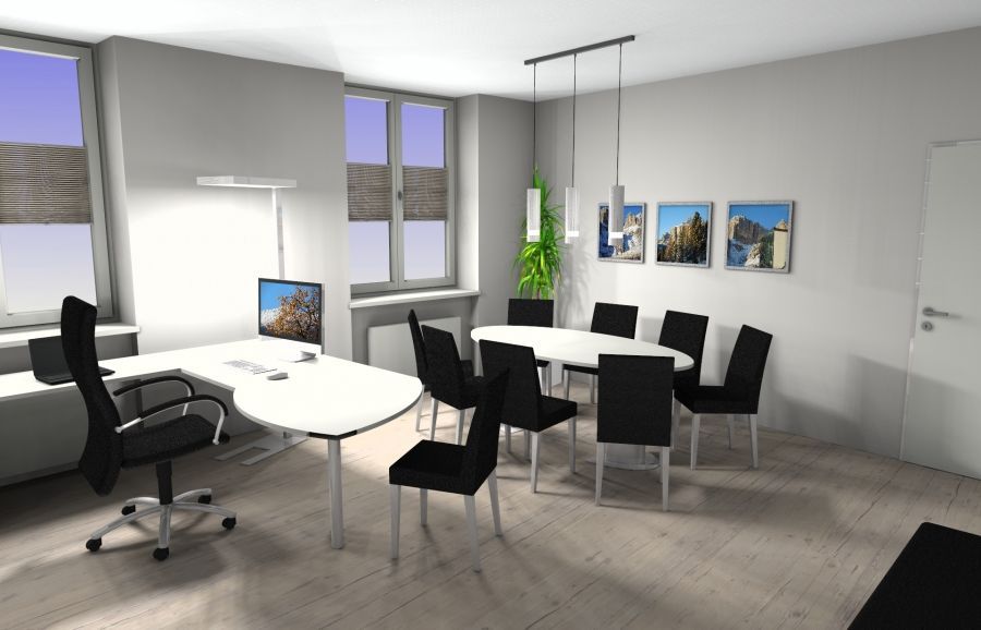 Ein modernes Büro mit einem L-förmigen Schreibtisch mit Computer und einem runden Besprechungstisch