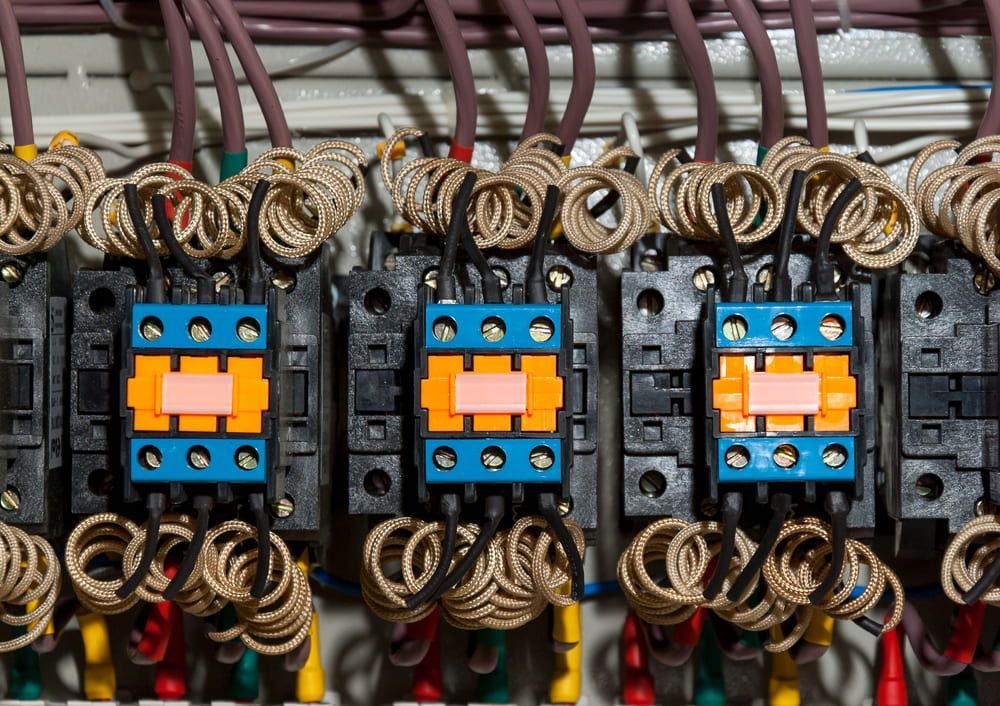 A Close Up Of A Row Of Electrical Switches And Wires — In Electrics In Mission Beach, QLD