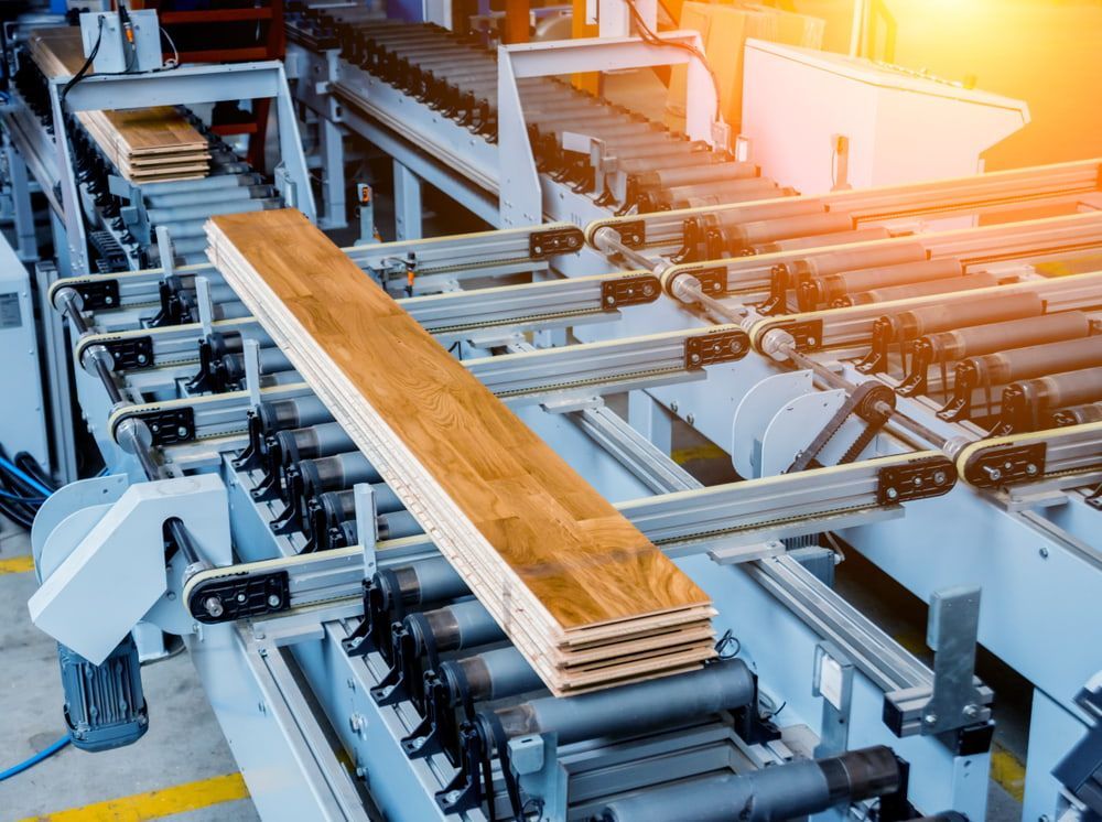 A Machine Is Cutting Wood In A Factory — In Electrics In Innisfail, QLD