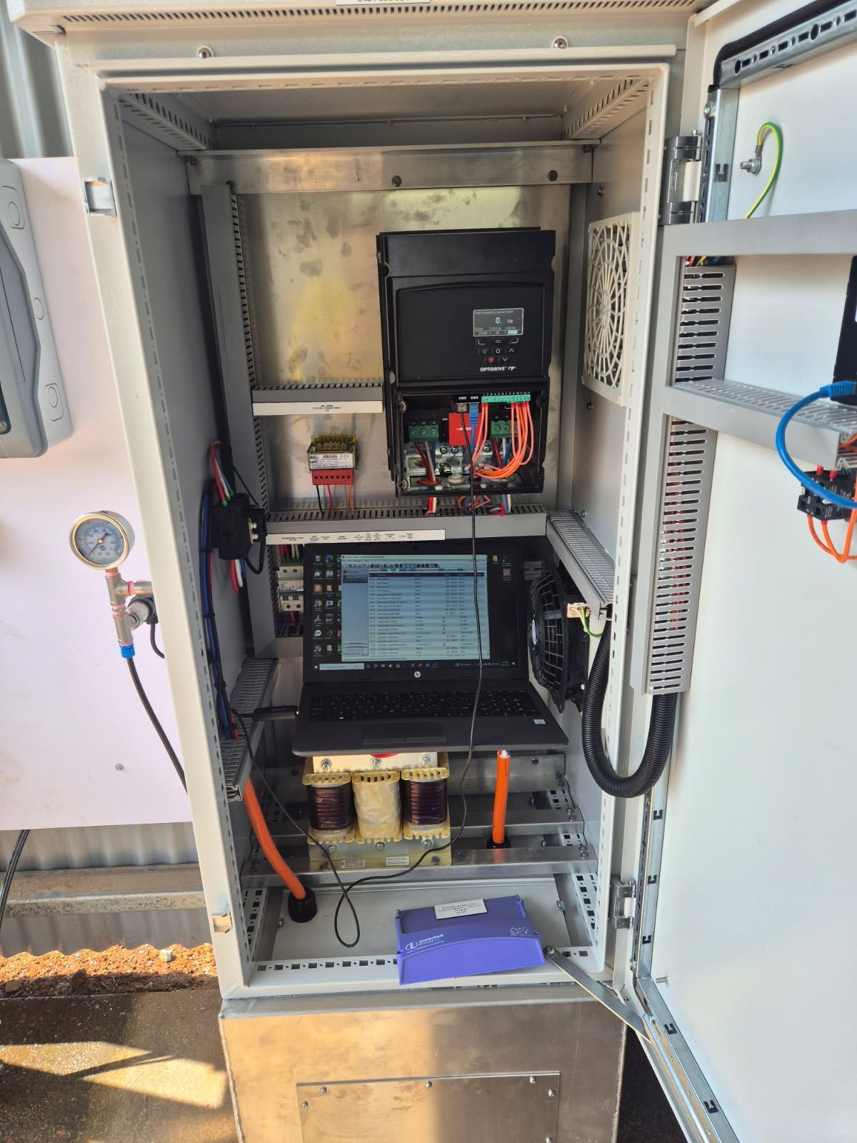 Two Men Are Working On An Air Conditioner With A Screwdriver — In Electrics In Cardwell, QLD