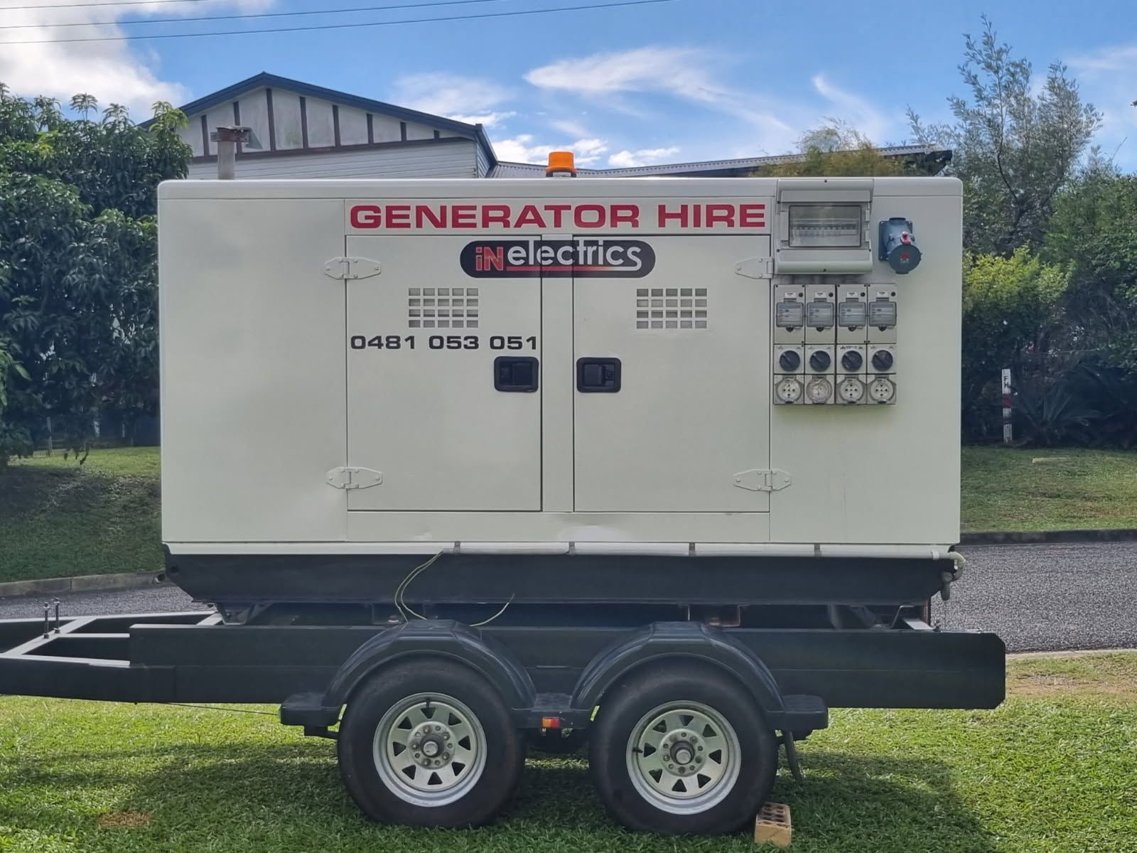 A Generator Is Sitting On A Trailer In A Parking Lot — In Electrics In Babinda, QLD