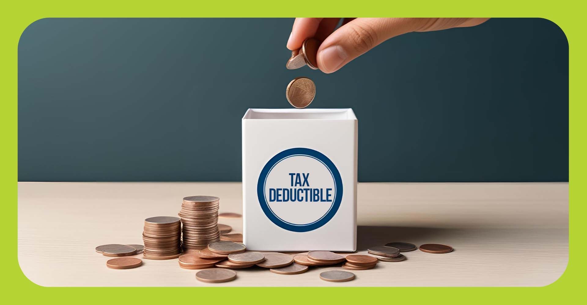 Hand putting change into a bank marked tax deductible