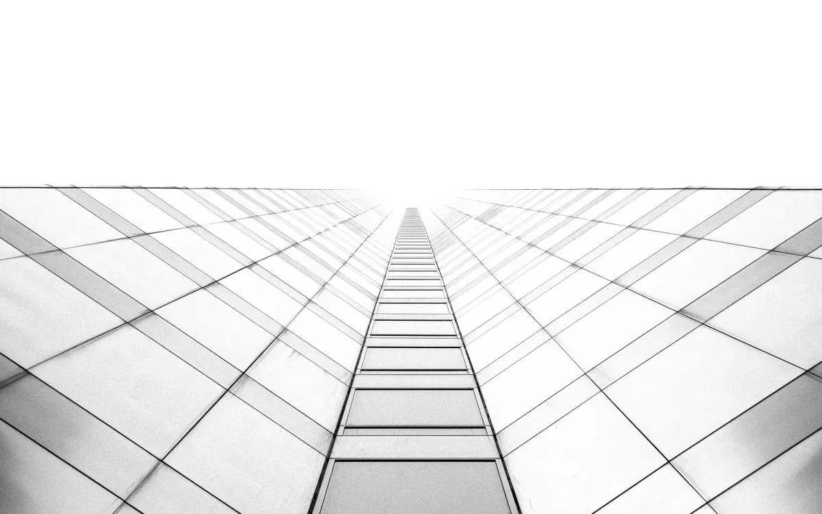 A black and white photo of a building with a staircase leading up to it.