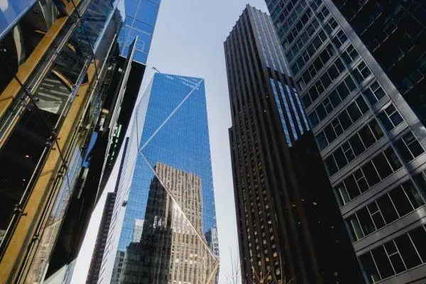 Looking up at a row of tall buildings in a city