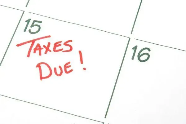 A calendar with the words taxes due written on it