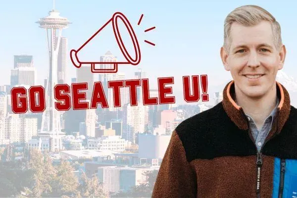 A man is standing in front of a sign that says go seattle u