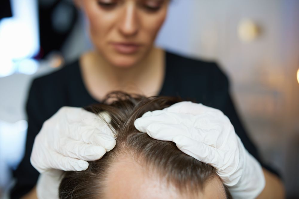 Person's Scalp Examined by a Gloved Hand — DAB Services in Cannonvale, QLD