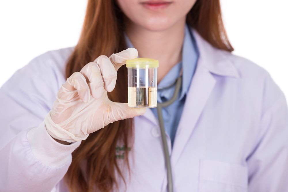 Lab Worker in Mask and Goggles, Holding a Test Tube in a Rack — DAB Services in Moranbah, QLD