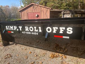 A dumpster with simply roll offs written on it