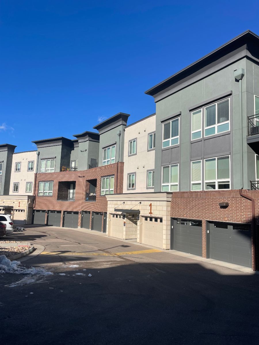 A row of apartment buildings with a blue sky in the background