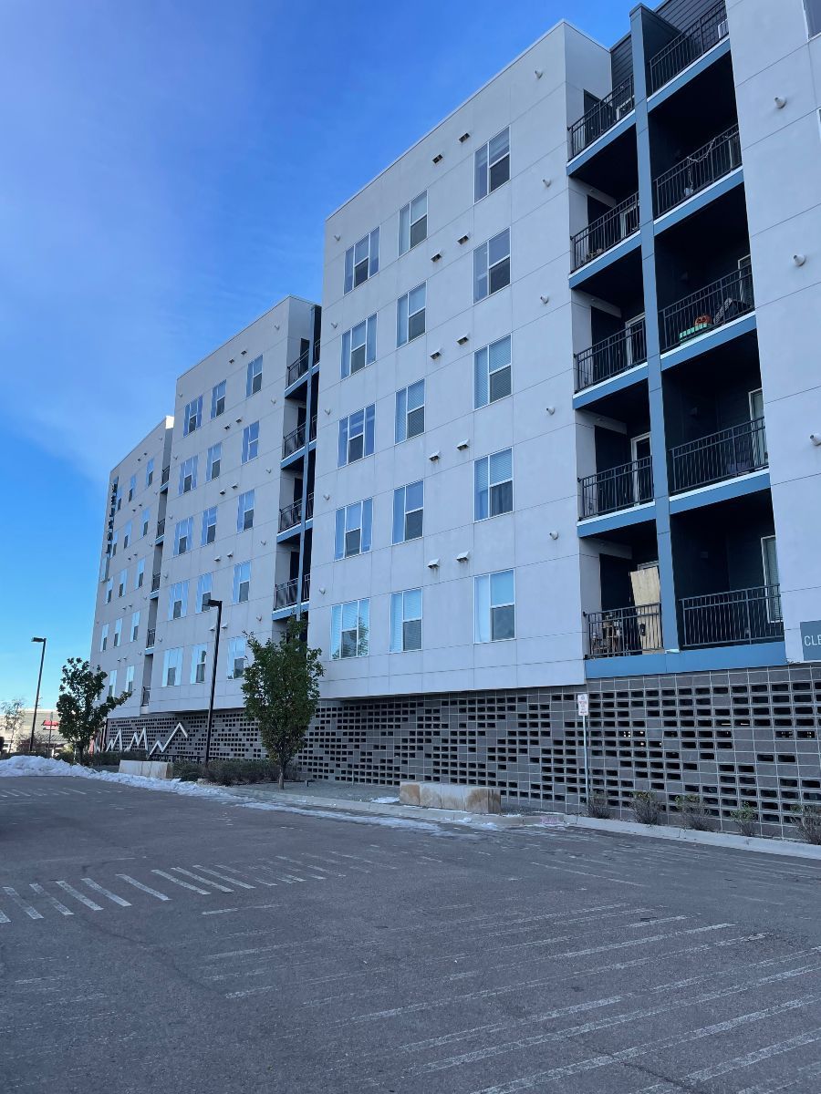 A large white building with a lot of windows and balconies