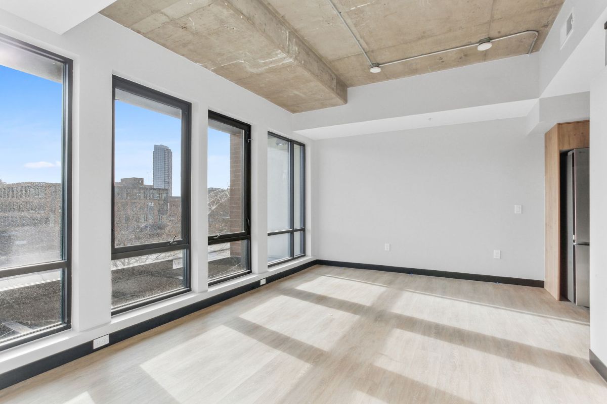 An empty room with a lot of windows and a ceiling.