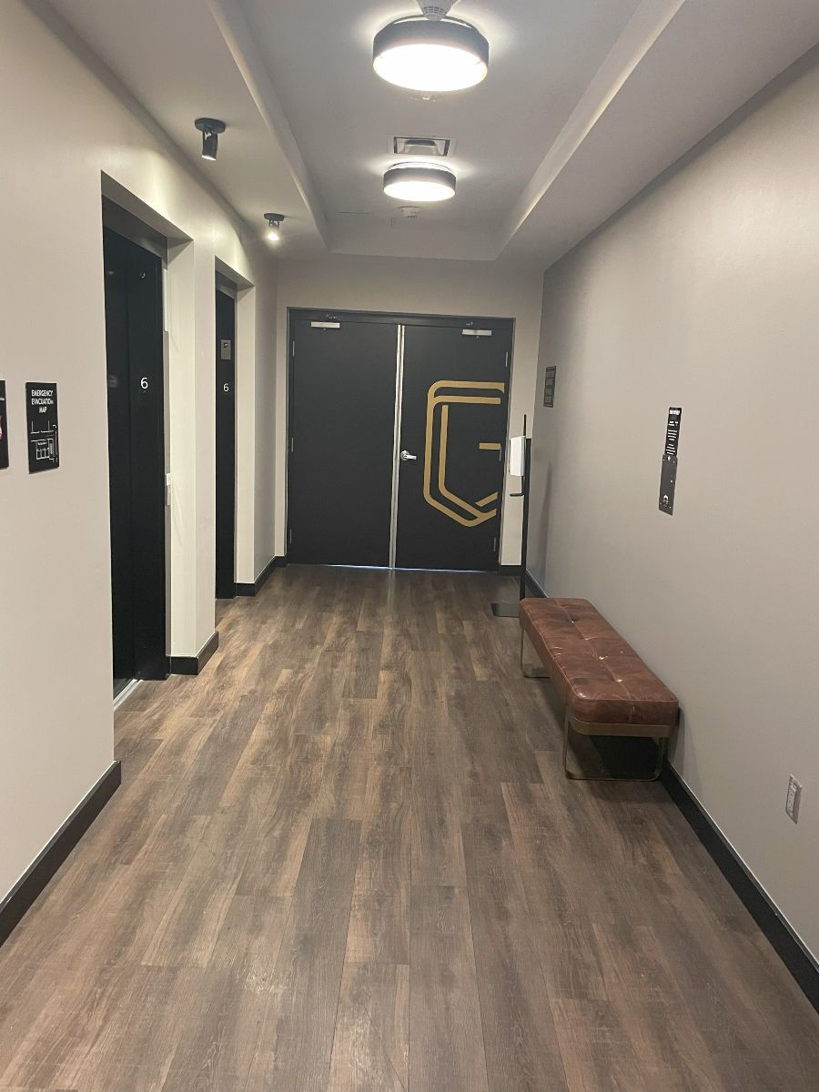 A long hallway with a bench in the middle