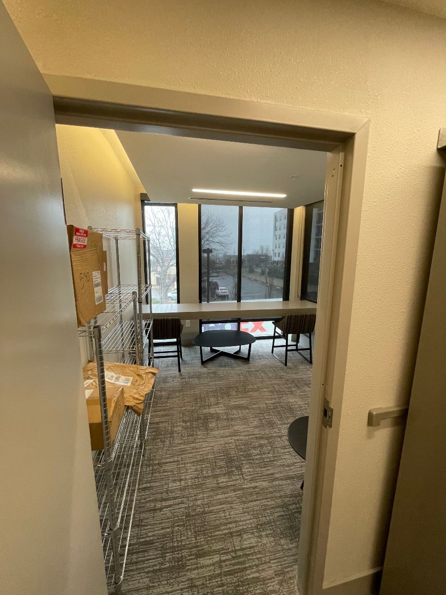 A doorway leading into a room with a table and chairs.