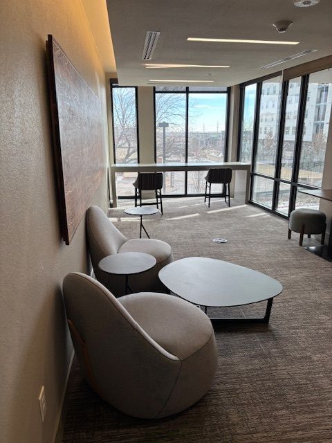 A room with a lot of windows and chairs and tables