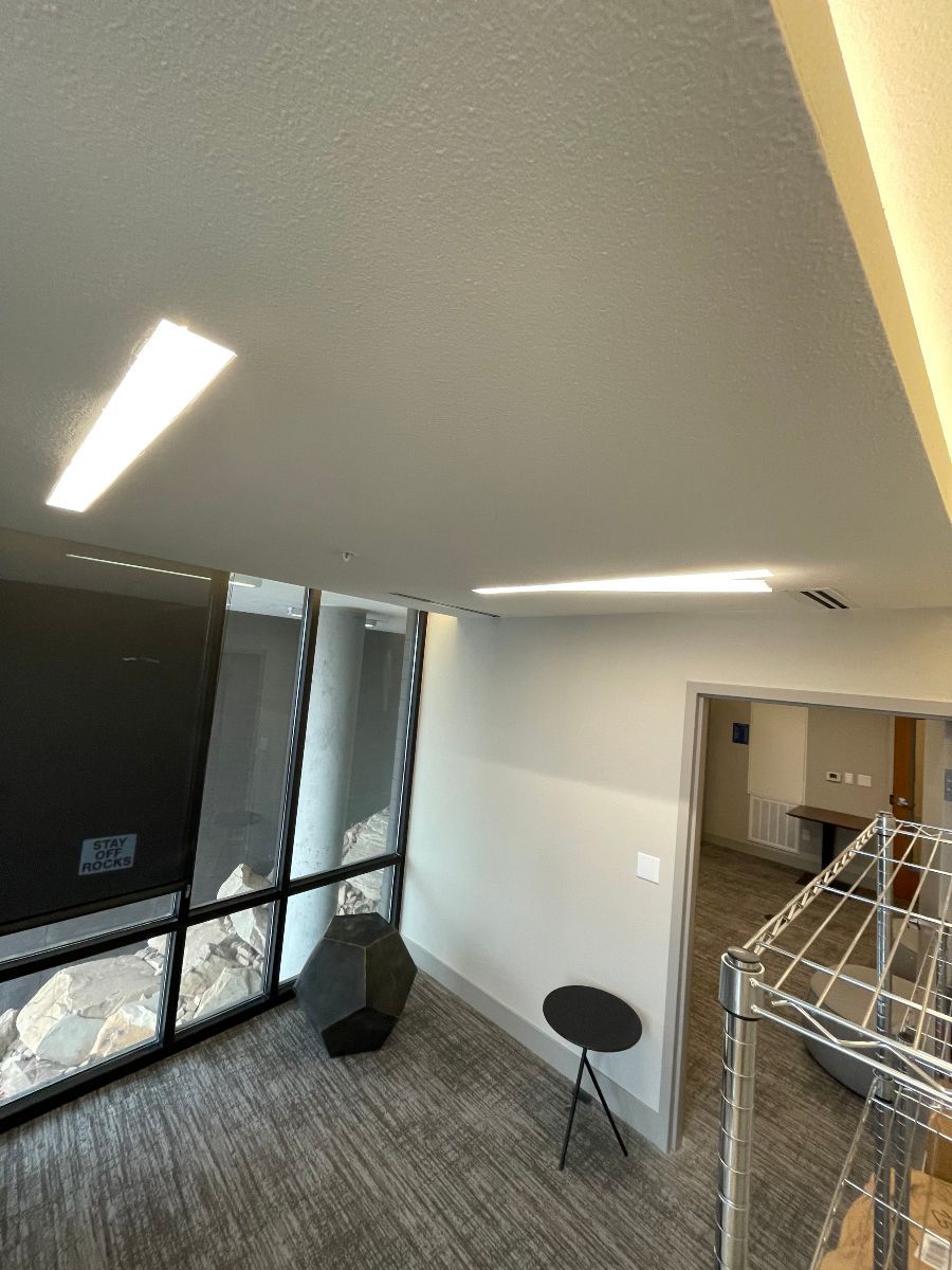 A room with a lot of windows and a table in it.