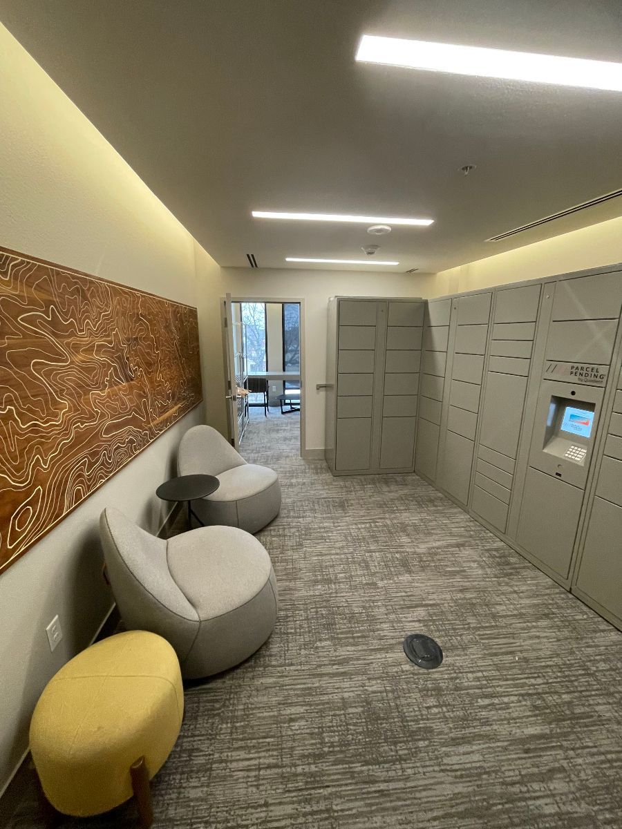 A room with two chairs and two ottomans in it.